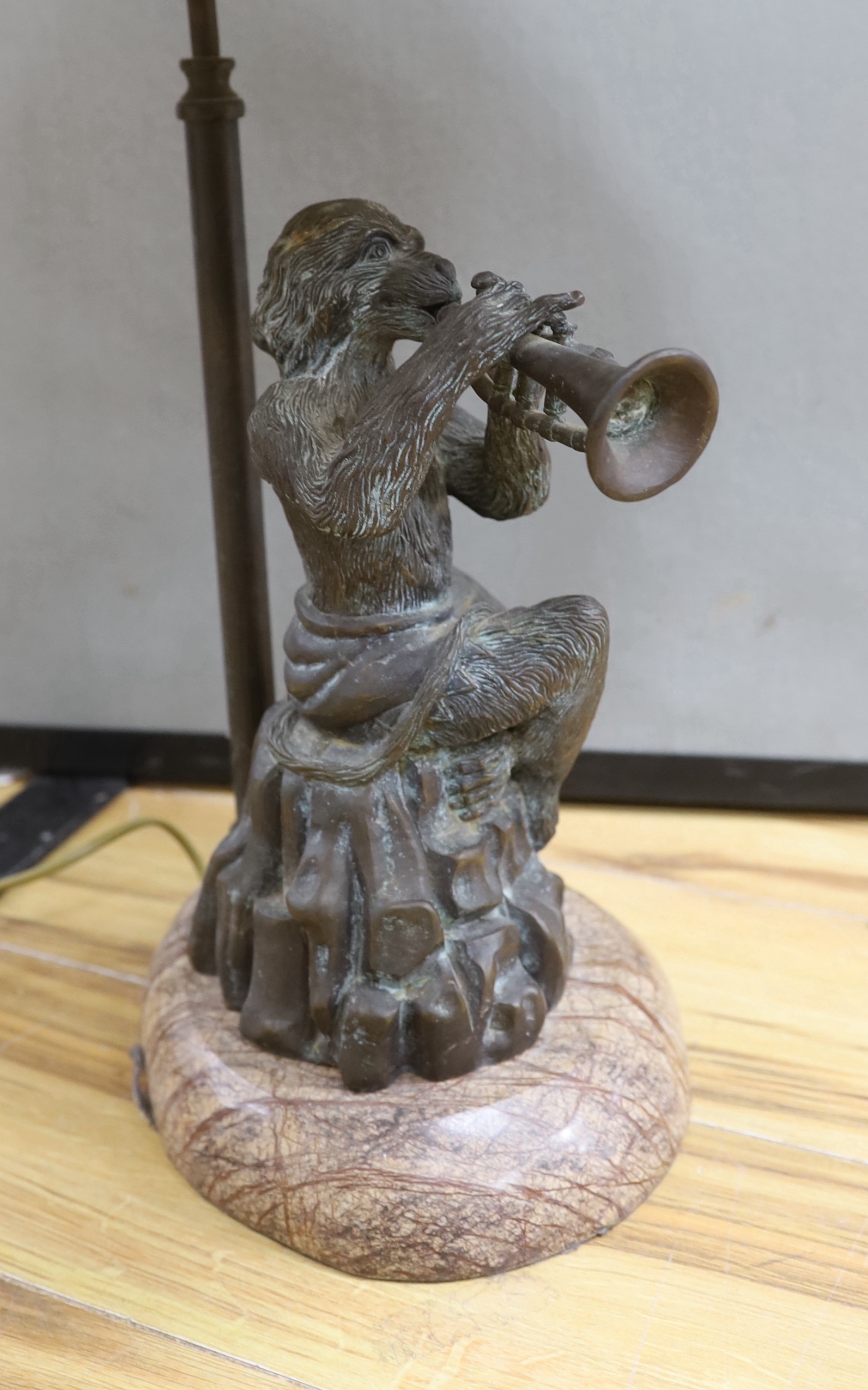 A bronzed metal monkey trumpet playing table lamp, approx. 70cm high including shade